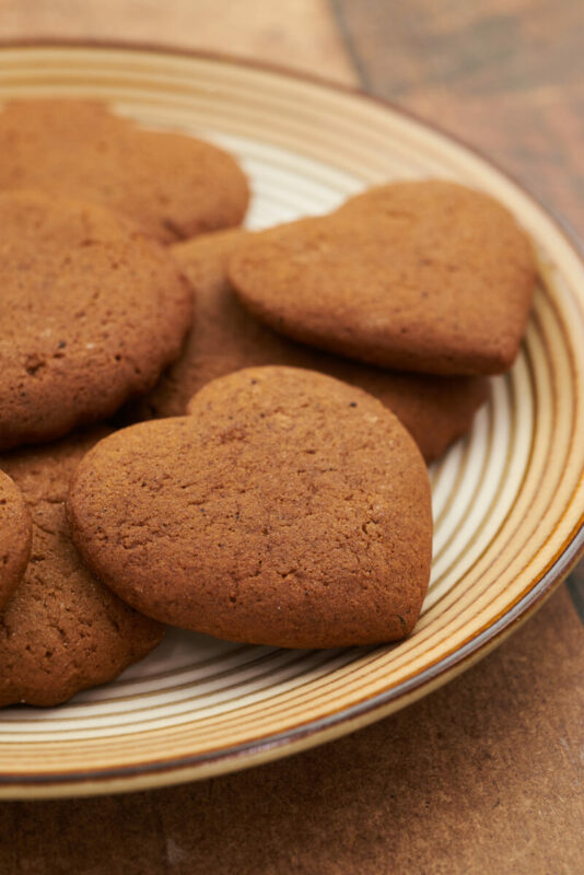 plate full of heart-shaped ginger snap cookies 